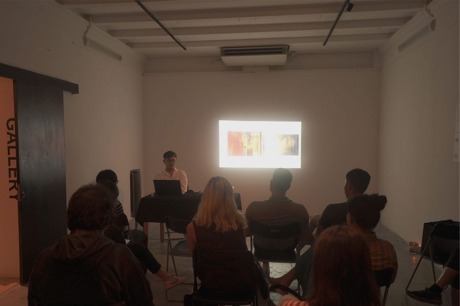 Dylan sharing his work at an artist talk.