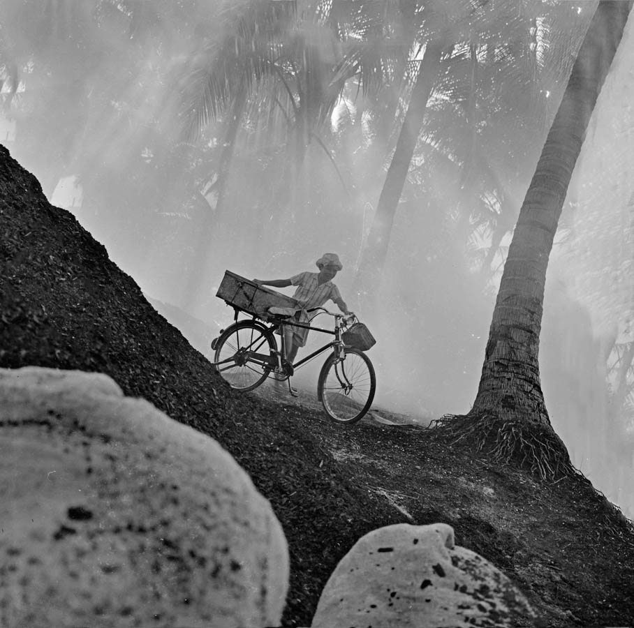 Time and Tide by Foo Tee Jun - Man pushes bicycle at Mata Ikan, c.1960s