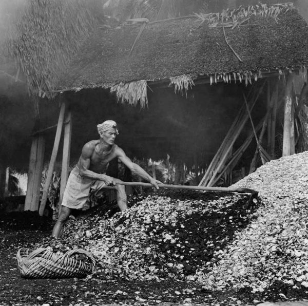 Time and Tide by Foo Tee Jun - Worker shovels seashells in Mata Ikan, c. 1960s
