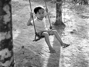 Time and Tide by Foo Tee Jun - Boy on swing, c. 1960s