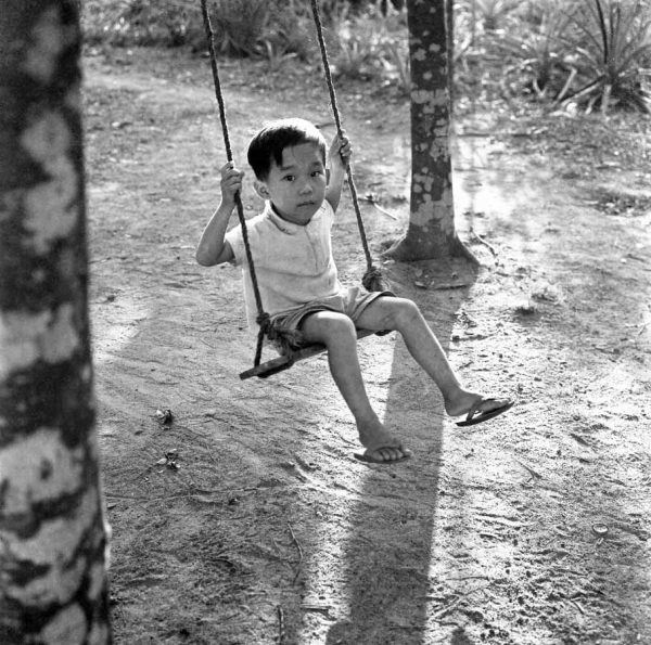 Time and Tide by Foo Tee Jun - Boy on swing, c. 1960s
