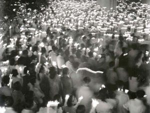 Time and Tide by Foo Tee Jun - Devotees attending night mass on Victoria Street, c. 1960s