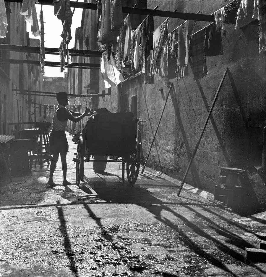 Time and Tide by Foo Tee Jun - Garbage collector at back alley, c. 1960s