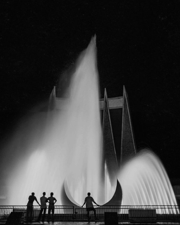 Time and Tide by Foo Tee Jun - Men silhouetted against fountain at National Theatre, c. 1960s