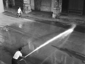 Time and Tide by Foo Tee Jun - Street washing on Chulia Street, c. 1960s