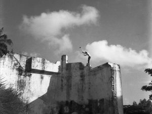 Time and Tide by Foo Tee Jun - Worker tears down walls of prison complex, 1963