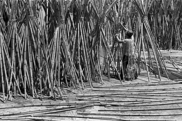 Time and Tide by Foo Tee Jun - Worker suns rattan after washing them in Kim Keat, c. 1970s