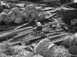 Time and Tide by Foo Tee Jun - Worker at docks along Kallang River, c. 1960s