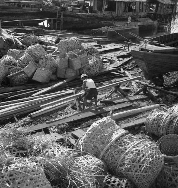 Time and Tide by Foo Tee Jun - Worker at docks along Kallang River, c. 1960s