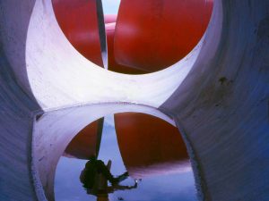 Time and Tide by Foo Tee Jun - Worker through concrete pipe at construction site, c. 1960s