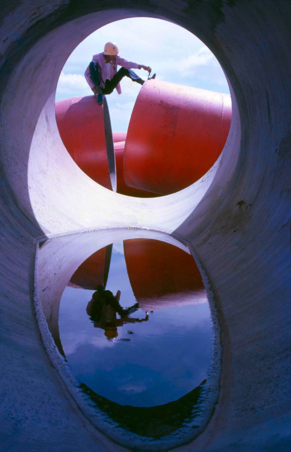 Time and Tide by Foo Tee Jun - Worker through concrete pipe at construction site, c. 1960s