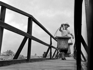 Passing Time by Lui Hock Seng - Man crossing bridge, Potong Pasir, c. 1960s – 1970s