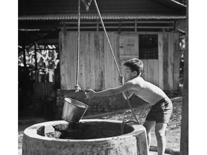 Passing Time by Lui Hock Seng - Boy fetching water from well, Lorong Tai Seng, c. 1970s
