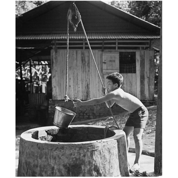 Passing Time by Lui Hock Seng - Boy fetching water from well, Lorong Tai Seng, c. 1970s