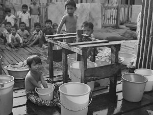 Passing Time by Lui Hock Seng - Children collecting water and waiting to clean up Jurong, c. 1960s – 1970s