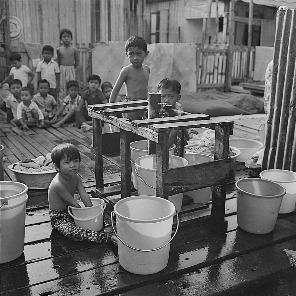 Passing Time by Lui Hock Seng - Children collecting water and waiting to clean up Jurong, c. 1960s – 1970s